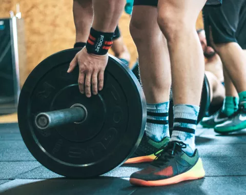 a person's hand trying lift weight