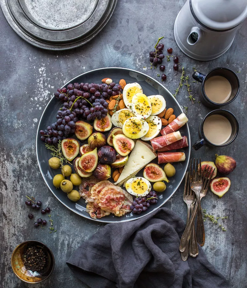 A bowl full of fruits with some extra flavor powder