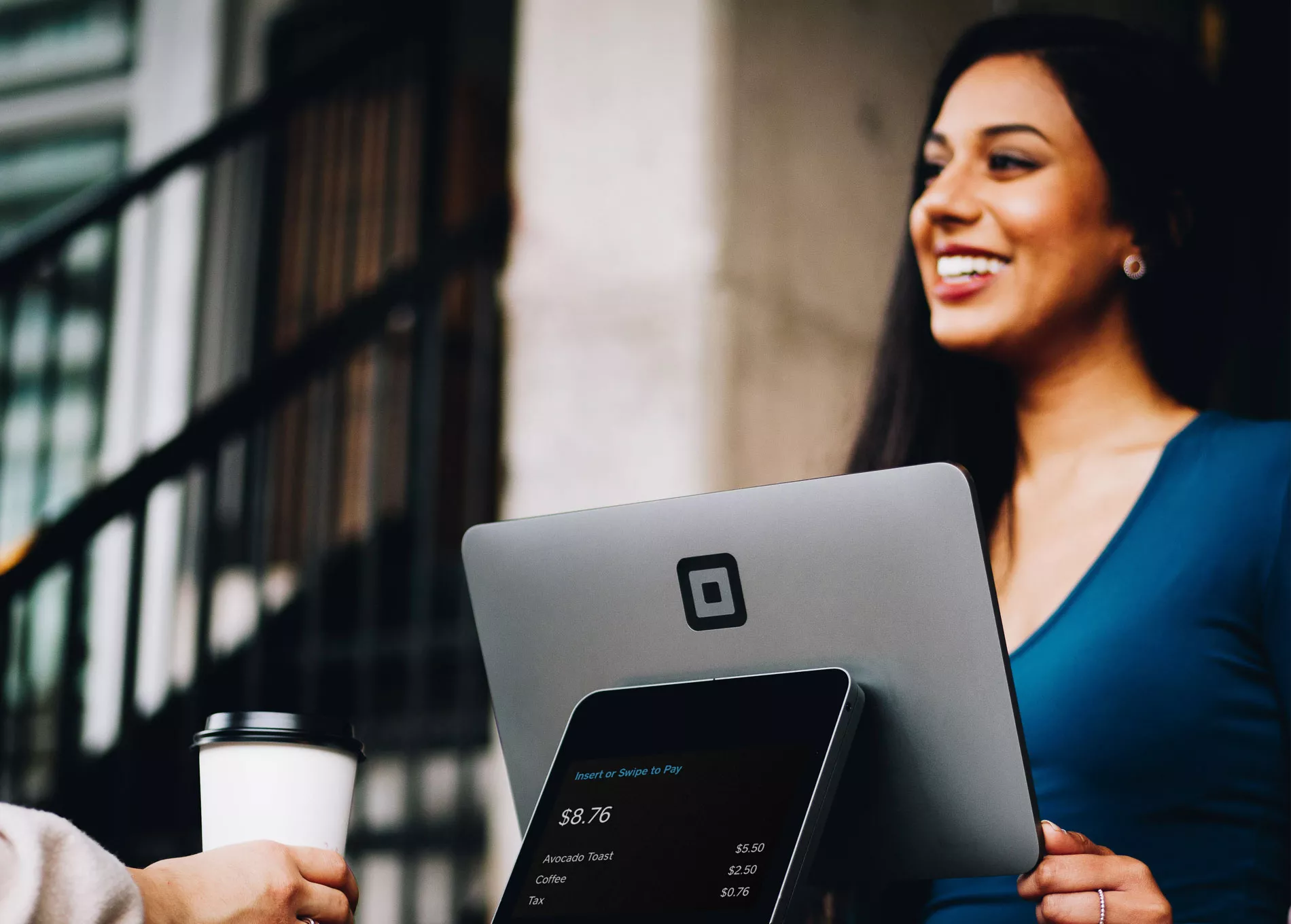 A woman having a happy conversation while holding Screen